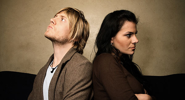 A photo of a couple with their backs to each other, after arguing. 